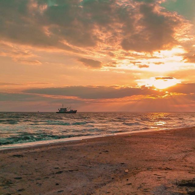 sea, sunset, horizon over water, water, beach, sky, scenics, beauty in nature, tranquil scene, tranquility, shore, orange color, cloud - sky, idyllic, nature, nautical vessel, sun, wave, sand, cloud