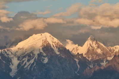 Scenic view of snowcapped mountains against sky during sunset