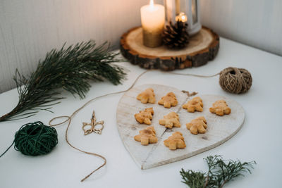 Cozy christmas mood. craft homemade cookies christmas tree shape in wooden tray on table with fir