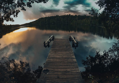 Pier over lake against sky