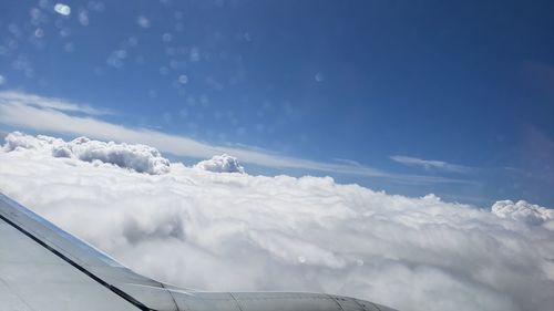 Low angle view of airplane flying against sky