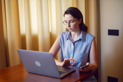 Young woman using laptop at home