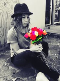 Midsection of woman holding flower bouquet