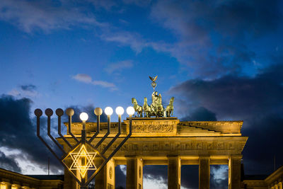 Low angle view of illuminated brandenburg gate against blue sky