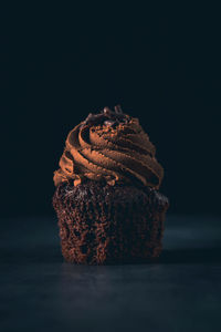 Close-up of chocolate cake against black background