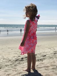 Rear view of girl walking on beach