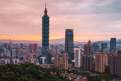 View of buildings against cloudy sky during sunset