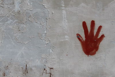 Close-up of hand on red surface