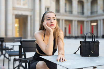 Young woman using mobile phone in cafe