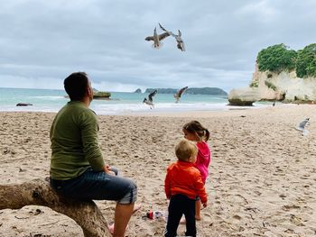 People on beach against sky