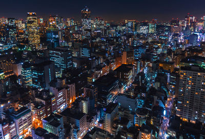 High angle view of illuminated city buildings at night