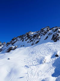 Idyllic view of snowcapped mountain against clear blue sky