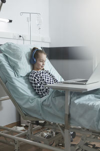 Portrait of woman using laptop at home