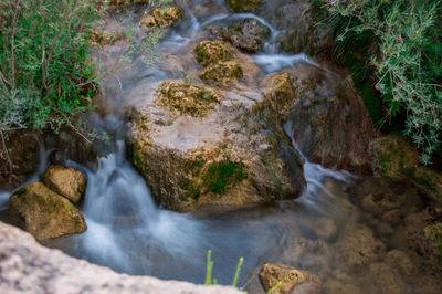 Stream flowing through rocks in forest