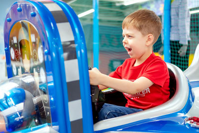 Rear view of boy looking at camera