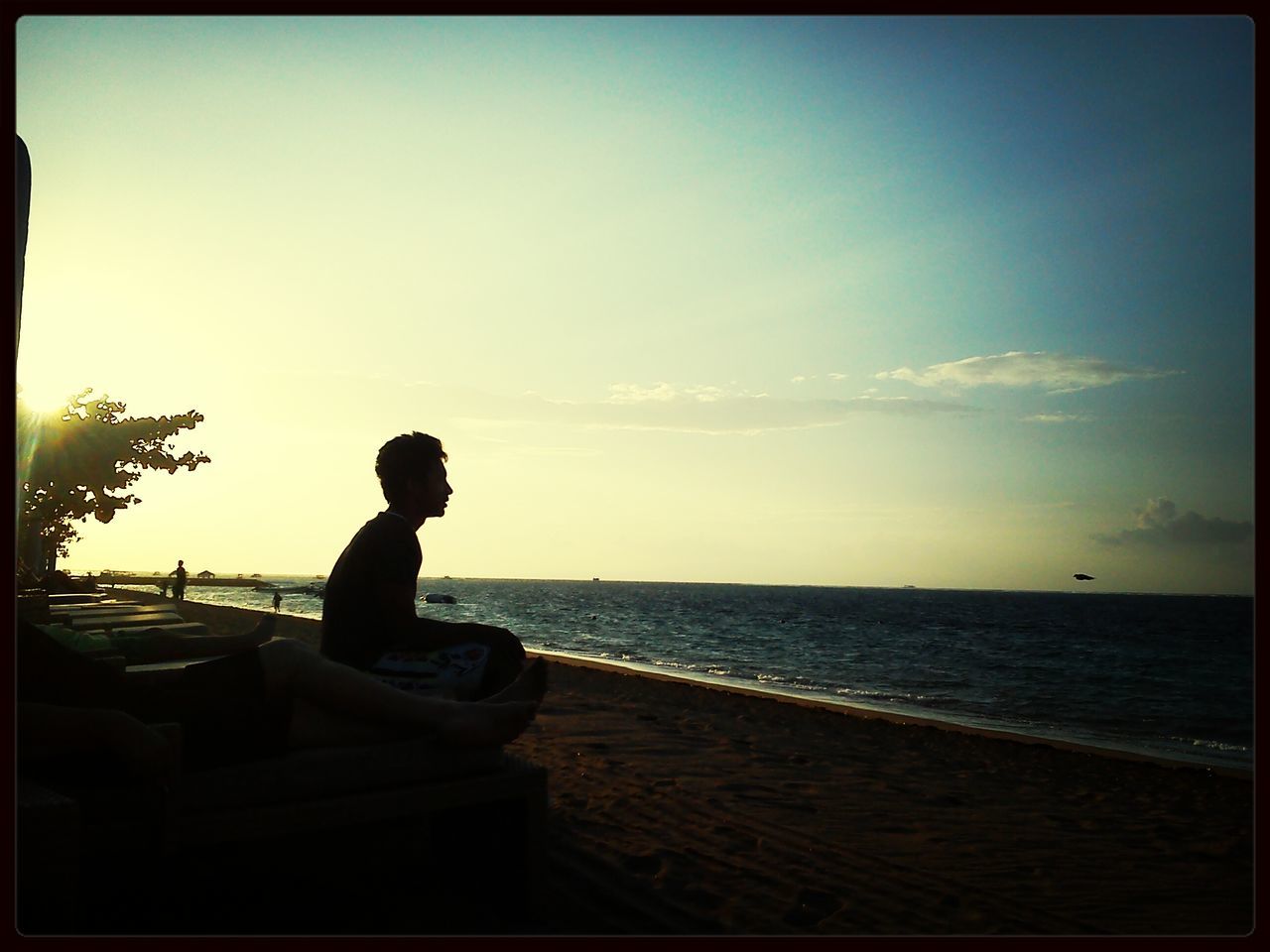 transfer print, sea, sky, water, horizon over water, auto post production filter, leisure activity, silhouette, lifestyles, full length, men, tranquility, sitting, tranquil scene, nature, cloud - sky, sunset, scenics