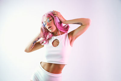 Close-up of beautiful woman standing against white background