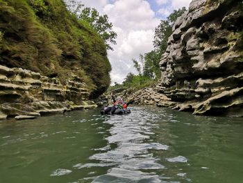 River amidst rocks against sky