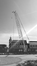 Low angle view of crane against sky