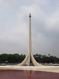View of communications tower against cloudy sky