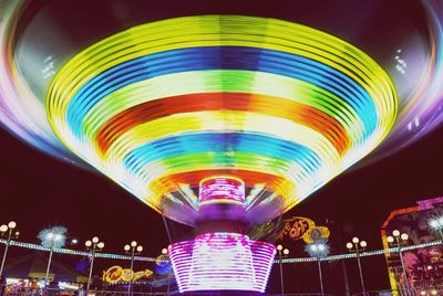 Low angle view of illuminated colorful lights at night