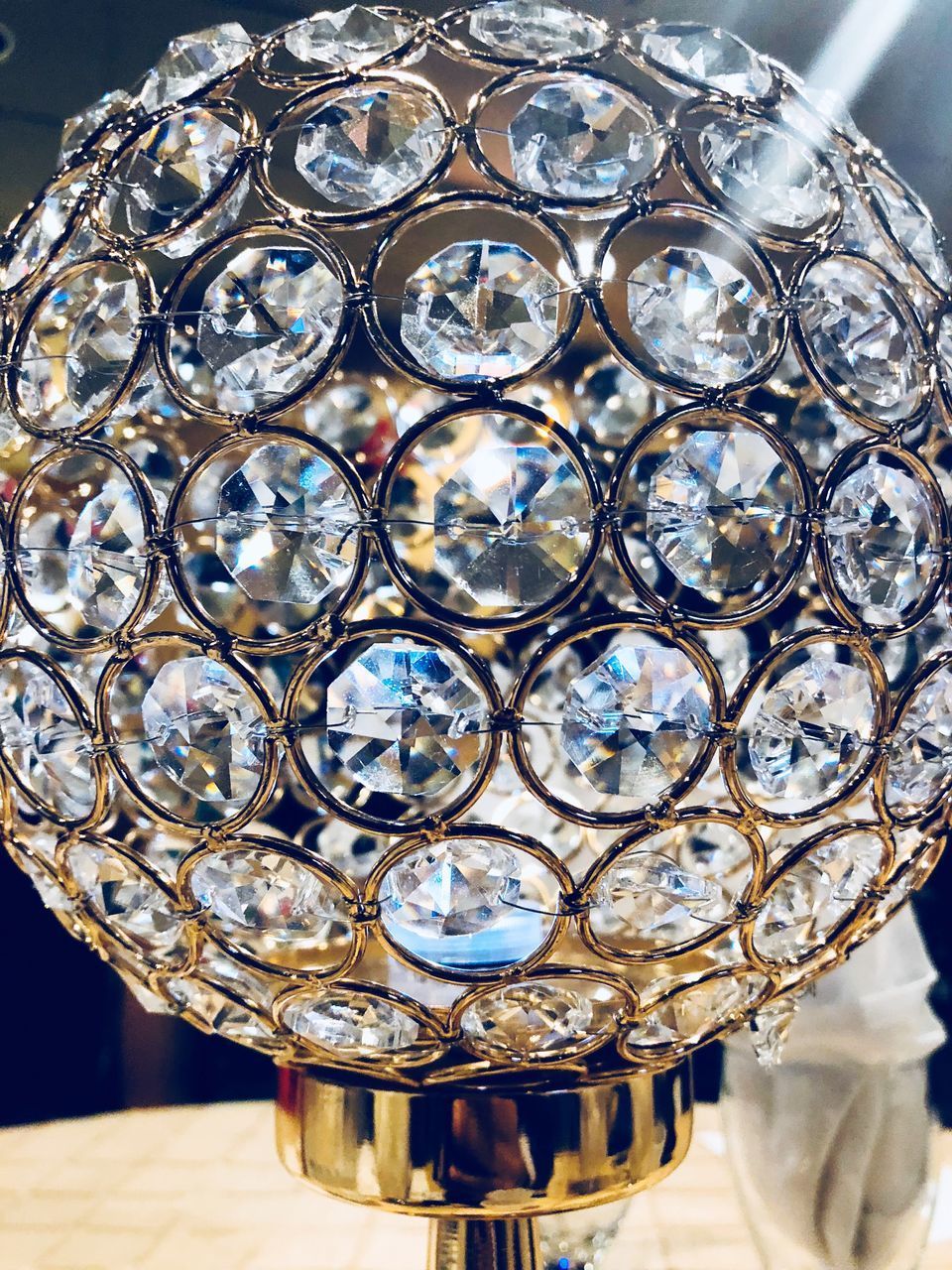 CLOSE-UP OF ORNATE GLASS ON TABLE WITH METAL GRATE