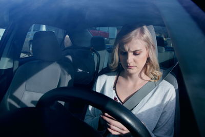 Young woman in car