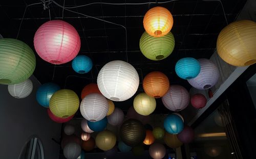 Low angle view of illuminated lanterns hanging on ceiling
