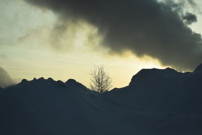 Low angle view of silhouette mountains against sky