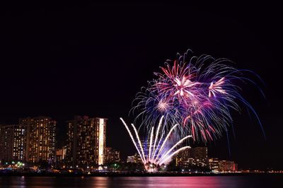 Firework display over city at night