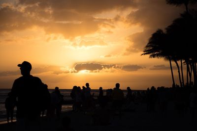 Silhouette of people on beach during sunset