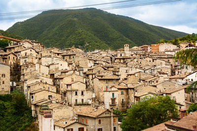 Buildings in town against sky