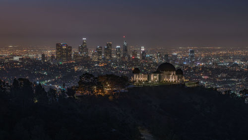 High angle view of city lit up at night