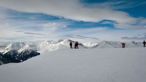 Tourists on snow covered mountain