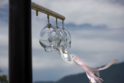 Close-up of water hanging against sky