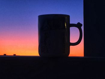 Close-up of beer on table against clear sky during sunset