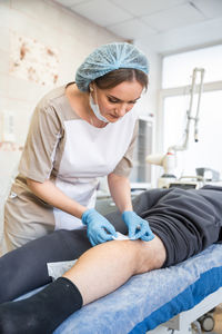 Low angle view of doctor examining patient in hospital