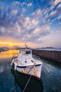 Fishing boat in port of naousa on sunset. paros lsland, greece
