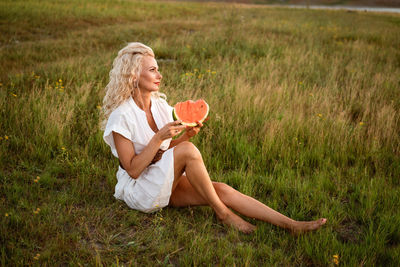 Portrait of a happy young woman enjoying and eating