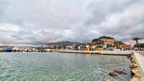 Panoramic view of sea and buildings against sky