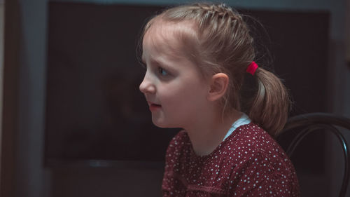 Side view of thoughtful girl at home