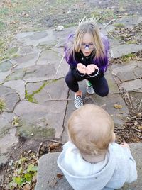 High angle portrait of cute girl on footpath