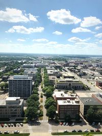 High angle view of buildings and trees against sky