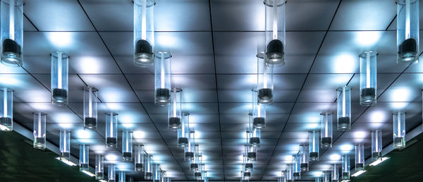 Low angle view of illuminated lights on ceiling at night
