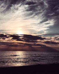 View of sea against cloudy sky during sunset