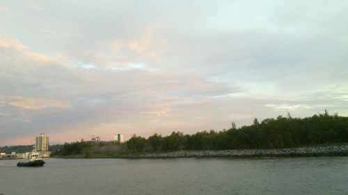 Scenic view of calm sea against cloudy sky