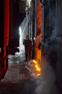 Manual worker molting iron in factory