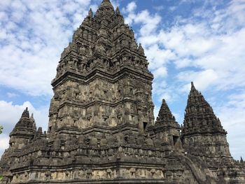 Low angle view of temple against cloudy sky