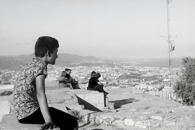 Rear view of woman sitting in park