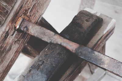 High angle view of rusty metal on wood